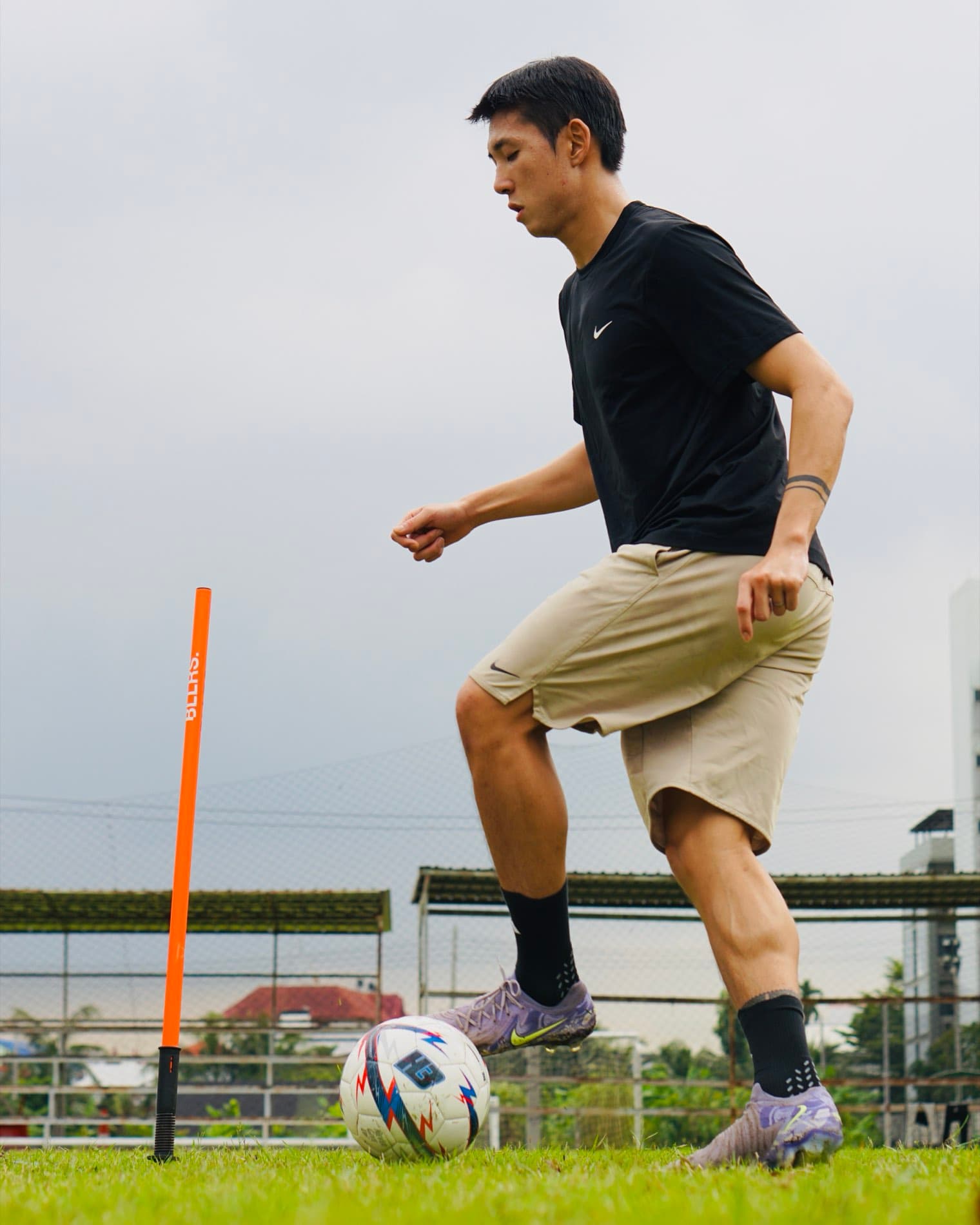 A player working the ball on grass in a BALLERS training session.
